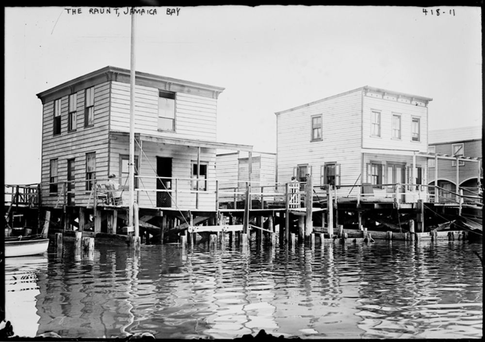 "During Prohibition, the many drinking establishments had to  shutter, or at least pretend to stop serving. After the Volstead Act was repealed, Seaside/The Rockaways again drew thirsty throngs. The Raunt was a marshy island community named for the Raunt Channel, which runs through the marshes of Jamaica Bay.  It was home to many popular fishing clubs, but after years of decline was razed and became part of Jamaica Bay’s bird sanctuary." (Courtesy of the Library of Congress)